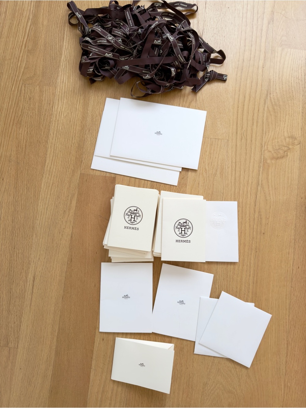 A bundle of Hermes packing ribbon and receipt holder envelopes etc